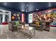 The themed game room features two couches and an immersive Marvel mural, creating an entertainment haven at 2927 Fable St, Kissimmee, FL 34746