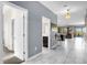 Hallway with tile floors leading to an open-concept living area and a bathroom at 2927 Fable St, Kissimmee, FL 34746