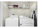 Functional laundry room with washer, dryer, storage shelf and ironing board at 2927 Fable St, Kissimmee, FL 34746