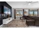Comfortable living room boasts large sectional, stylish rug, and textured wall with mounted TV at 2927 Fable St, Kissimmee, FL 34746