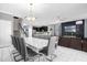 Open floor plan showcases dining, kitchen, and living areas, designed for seamless flow and modern living at 2927 Fable St, Kissimmee, FL 34746
