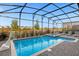 Private screened-in pool and spa, surrounded by a brick deck with comfortable lounge chairs at 2927 Fable St, Kissimmee, FL 34746