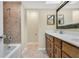 Bathroom featuring a bathtub, tile, and vanity with double sinks at 3217 Castle Oak Ave, Orlando, FL 32808
