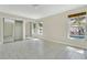 Bright bedroom showcasing tile floors, natural light, and mirrored closet at 3217 Castle Oak Ave, Orlando, FL 32808