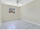 This bedroom offers neutral walls and ceramic tile floors, providing an airy feel at 3217 Castle Oak Ave, Orlando, FL 32808