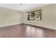 Bright bedroom with wood floors and large window offering natural light and scenic views at 3217 Castle Oak Ave, Orlando, FL 32808