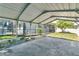 Wide carport, offering a functional space for parking or storage with views of pool and screened patio at 3217 Castle Oak Ave, Orlando, FL 32808