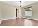 Cozy dining space with hardwood floors, a modern chandelier, and a window with natural light at 3217 Castle Oak Ave, Orlando, FL 32808