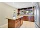 Stylish kitchen with granite countertops, a central island with drawer storage, and stainless steel refrigerator at 3217 Castle Oak Ave, Orlando, FL 32808