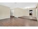 Spacious living area featuring hardwood floors, neutral walls, and an archway leading to the kitchen at 3217 Castle Oak Ave, Orlando, FL 32808