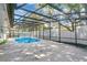 An overhead shot of the pool enclosure, looking towards the fenced backyard at 3217 Castle Oak Ave, Orlando, FL 32808