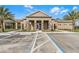 Community building with tan walls, stone columns, and accessible parking spaces in front at 3334 Arch Ave, Ormond Beach, FL 32174