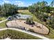 Aerial view of the community playground, tennis courts, and other recreational amenities at 3334 Arch Ave, Ormond Beach, FL 32174