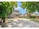 The house has a wooden patio with a pergola and a large backyard for outdoor activities at 338 E Anderson St, Orlando, FL 32801