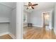This bedroom has hardwood floors, neutral paint, a ceiling fan, a window, and access to an ensuite bathroom at 338 E Anderson St, Orlando, FL 32801