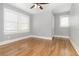 This bedroom has hardwood floors, neutral paint, two windows with window coverings, and a ceiling fan at 338 E Anderson St, Orlando, FL 32801