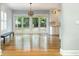 Elegant dining space with wood floors, decorative lighting, and sliding glass doors to the backyard at 338 E Anderson St, Orlando, FL 32801