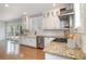 Bright kitchen features granite countertops, white cabinets, stainless steel appliances, and a farmhouse sink at 338 E Anderson St, Orlando, FL 32801