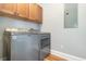This laundry area features a modern Maytag washer and dryer, hardwood floors, and upper cabinets for storage at 338 E Anderson St, Orlando, FL 32801