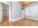 This living room has hardwood floors, an adjoining stairwell, access to another room, and two large windows at 338 E Anderson St, Orlando, FL 32801