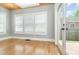This light-filled living room features hardwood floors, neutral paint, a tongue and groove ceiling, and access to the back yard at 338 E Anderson St, Orlando, FL 32801
