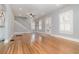Spacious living area featuring hardwood flooring, staircase, white trim, and shuttered windows at 338 E Anderson St, Orlando, FL 32801