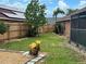 Expansive backyard with solar panels, wood fence, seating area and screened enclosure at 340 Haversham Way, Davenport, FL 33897