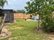 Cozy backyard featuring a seating area with Adirondack chairs and wood fence at 340 Haversham Way, Davenport, FL 33897