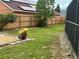 Well-maintained backyard with wood fence, solar panels, and a convenient screened enclosure at 340 Haversham Way, Davenport, FL 33897
