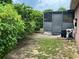 Backyard featuring mature trees and a screened enclosure with pool equipment at 340 Haversham Way, Davenport, FL 33897