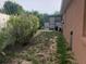 A view of the backyard featuring a screened-in lanai, tropical plants, and the exterior wall of the home at 340 Haversham Way, Davenport, FL 33897