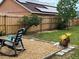 Spacious backyard with a wood fence, solar panels, and a charming seating area at 340 Haversham Way, Davenport, FL 33897