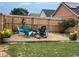 Beautiful backyard seating area with multiple chairs around a central fire pit and wood fence at 340 Haversham Way, Davenport, FL 33897