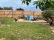 Inviting backyard seating area with Adirondack chairs around a gravel area and wood fence at 340 Haversham Way, Davenport, FL 33897