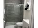 Modern bathroom featuring a glass-enclosed shower, sleek vanity, and stylish gray tile work at 340 Haversham Way, Davenport, FL 33897