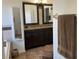 Bathroom with a double vanity, granite countertop, and tiled walls at 340 Haversham Way, Davenport, FL 33897