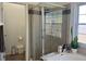 Bathroom featuring a large glass enclosed shower, tub, and neutral tiling at 340 Haversham Way, Davenport, FL 33897