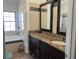 Elegant bathroom featuring a double vanity with granite countertop and decorative tile backsplash at 340 Haversham Way, Davenport, FL 33897