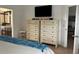 Bedroom view to a bathroom and flat-screen TV, featuring drawers for organized storage and functionality at 340 Haversham Way, Davenport, FL 33897