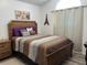 Comfortable bedroom with wooden furniture and an Eiffel Tower decoration, perfect for relaxation at 340 Haversham Way, Davenport, FL 33897