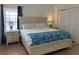 Comfortable bedroom featuring a large window, two bedside tables, and a spacious closet for storage at 340 Haversham Way, Davenport, FL 33897