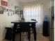 Cozy dining area features a unique table with seating and modern amenities, perfect for intimate meals at 340 Haversham Way, Davenport, FL 33897