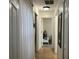 Hallway with access to bedrooms and a peek into the living area, showcasing an open floorplan at 340 Haversham Way, Davenport, FL 33897