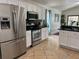 Updated kitchen showcasing stainless steel appliances, white cabinetry, and ample counter space for cooking at 340 Haversham Way, Davenport, FL 33897