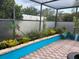 A screened-in lanai with plants and brick-paved floor, creating a relaxing outdoor space at 340 Haversham Way, Davenport, FL 33897