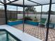 Screened-in patio with planters and comfortable chairs for enjoying the outdoors at 340 Haversham Way, Davenport, FL 33897