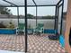 Enclosed patio with brick pavers, lush planters, and comfortable seating at 340 Haversham Way, Davenport, FL 33897