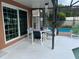 Enclosed patio area with dining set for enjoying meals and relaxing by the pool at 340 Haversham Way, Davenport, FL 33897