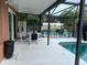 Screened-in pool with dining area and lounge chairs for outdoor enjoyment at 340 Haversham Way, Davenport, FL 33897