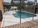 Screened-in pool area with an outdoor seating area, perfect for relaxing and entertaining at 340 Haversham Way, Davenport, FL 33897